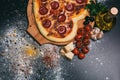 Pizza heart shaped with pepperoni, tomatoes, mozzarella, garlic and parsley Royalty Free Stock Photo