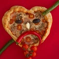 Pizza heart shaped on red