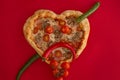 Pizza heart shaped on red