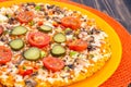 Pizza hommemade on orange plate. Royalty Free Stock Photo