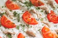 Pizza ingredients are closeup. Tomatoes, chicken, cheese, dill.