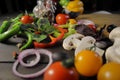 Pizza ingredients vegetables on black table