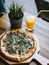 Pizza vegetable on wooden plate with orange juice. Royalty Free Stock Photo