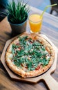 Pizza vegetable on wooden plate with orange juice. Royalty Free Stock Photo