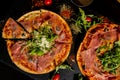 Pizza Jamon IbÃÂ©rico and Rocket salad served on slate table