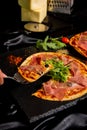 Pizza Jamon IbÃÂ©rico and Rocket salad served on slate table