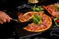 Pizza Jamon IbÃÂ©rico and Rocket salad served on slate table