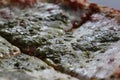 Pizza Magherita with green pesto on it and a nice and crispy edge with cheese