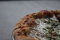 Pizza Magherita with green pesto on it and a nice and crispy edge with cheese