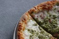 Pizza Magherita with green pesto on it and a nice and crispy edge with cheese