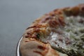 Pizza Magherita with green pesto on it and a nice and crispy edge with cheese