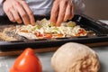 Pizza maker prepares vegetarian pizza, puts out the ingredients Royalty Free Stock Photo