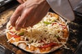 Pizza maker prepares vegetarian pizza, puts out the ingredients Royalty Free Stock Photo