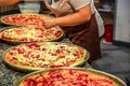 Pizza maker preparing pizzas