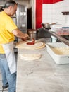 Pizza Maker puts on the sauce Royalty Free Stock Photo