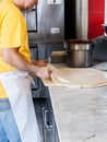 Pizza Maker stretches a Fresh Pizza dough