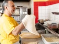 Pizza Maker twirls a Fresh Pizza dough Royalty Free Stock Photo