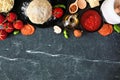 Pizza making ingredients top border against a dark background Royalty Free Stock Photo