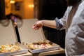 Male chef hands making pizza in the pizzeria kitchen