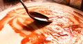 Pizza making process. Pizza dough covered with red tomato sauce Royalty Free Stock Photo