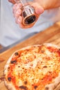 Pizza Margarita. Baked tasty margherita pizza in Traditional wood oven in Neapolitan restaurant, Italy. Royalty Free Stock Photo