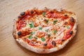 Pizza Margarita. Baked tasty margherita pizza in Traditional wood oven in Neapolitan restaurant, Italy. Royalty Free Stock Photo