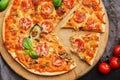 Pizza Margarita with cherry tomatoes, mozzarella and Basil on a cutting Board. Cut off a slice of pizza. The view from the top, Royalty Free Stock Photo