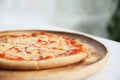 Pizza margarita on wooden tray in coffee shop Royalty Free Stock Photo