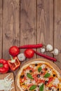 Pizza Margherita or Margarita with Mozzarella cheese, tomato, olive. Italian pizza on wooden background Royalty Free Stock Photo