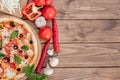 Pizza Margherita or Margarita with Mozzarella cheese, tomato, olive. Italian pizza on wooden background Royalty Free Stock Photo