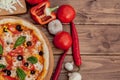 Pizza Margherita or Margarita with Mozzarella cheese, tomato, olive. Italian pizza on wooden background Royalty Free Stock Photo