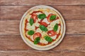 Pizza Margherita with tomatoes, mozzarella and basil