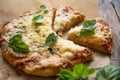 Pizza Margherita on wooden background top view. Pizza Margarita with vegetable Basil and Mozzarella Cheese close up.