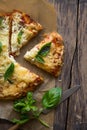 Pizza Margherita on wooden background top view. Pizza Margarita with vegetable Basil and Mozzarella Cheese close up.