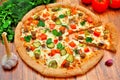 Pizza with meat, cucumbers, tomatoes and greens