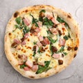 Pizza with meat, mushrooms and spinach close up on gray concrete background. italian pizza top view Royalty Free Stock Photo