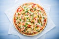 Pizza with mozzarella cheese, chicken, sweet corn, sweet pepper and parsley on blue wooden background top view Royalty Free Stock Photo