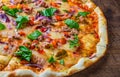 Pizza with Mozzarella cheese, onion, tuna fish, tomato sauce, pepper, basil. Italian pizza on wooden table Royalty Free Stock Photo