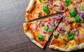 Pizza with Mozzarella cheese, onion, tuna fish, tomato sauce, pepper, basil. Italian pizza on wooden table Royalty Free Stock Photo