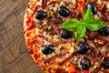 Pizza with Mozzarella cheese, salami, pepper, ham, pepperoni, olives, Spices and Fresh Basil. Italian pizza Royalty Free Stock Photo