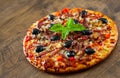 Pizza with Mozzarella cheese, salami, pepper, ham, pepperoni, olives, Spices and Fresh Basil. Italian pizza Royalty Free Stock Photo