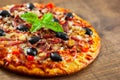 Pizza with Mozzarella cheese, salami, pepper, ham, pepperoni, olives, Spices and Fresh Basil. Italian pizza Royalty Free Stock Photo