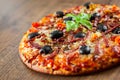 Pizza with Mozzarella cheese, salami, pepper, ham, pepperoni, olives, Spices and Fresh Basil. Italian pizza Royalty Free Stock Photo