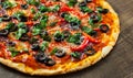 Pizza with Mozzarella cheese, salami, pepper, pepperoni, Tomatoes, olives, Spices and Fresh Basil. Italian pizza Royalty Free Stock Photo