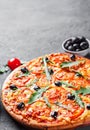 Pizza with Mozzarella cheese, Tomatoes, pepper, olive, Spices and Fresh arugula. Italian pizza. Pizza Margherita or Margarita Royalty Free Stock Photo