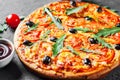 Pizza with Mozzarella cheese, Tomatoes, pepper, olive, Spices and Fresh arugula. Italian pizza. Pizza Margherita or Margarita Royalty Free Stock Photo
