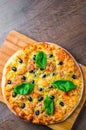 Pizza with Mozzarella cheese, Tomatoes, pepper, olive, Spices and Fresh Basil. Italian pizza. Pizza Margherita or Margarita on woo Royalty Free Stock Photo