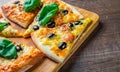 Pizza with Mozzarella cheese, Tomatoes, pepper, olive, Spices and Fresh Basil. Italian pizza. Pizza Margherita or Margarita on woo Royalty Free Stock Photo