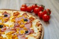 Pizza with mozzarella cheese, truffles, onion, ham and corn detail