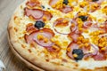 Pizza with mozzarella cheese, truffles, onion, ham and corn detail crust